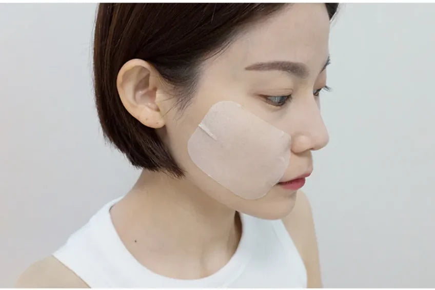 A woman in profile with a single toner pad resting on her cheek