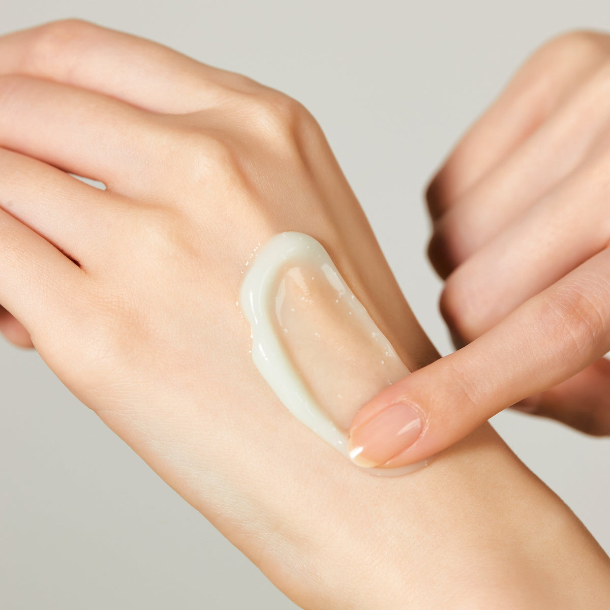 Jeju Yuja Cera Balancing Cream — a swipe of pale green gel-cream on the back of a hand