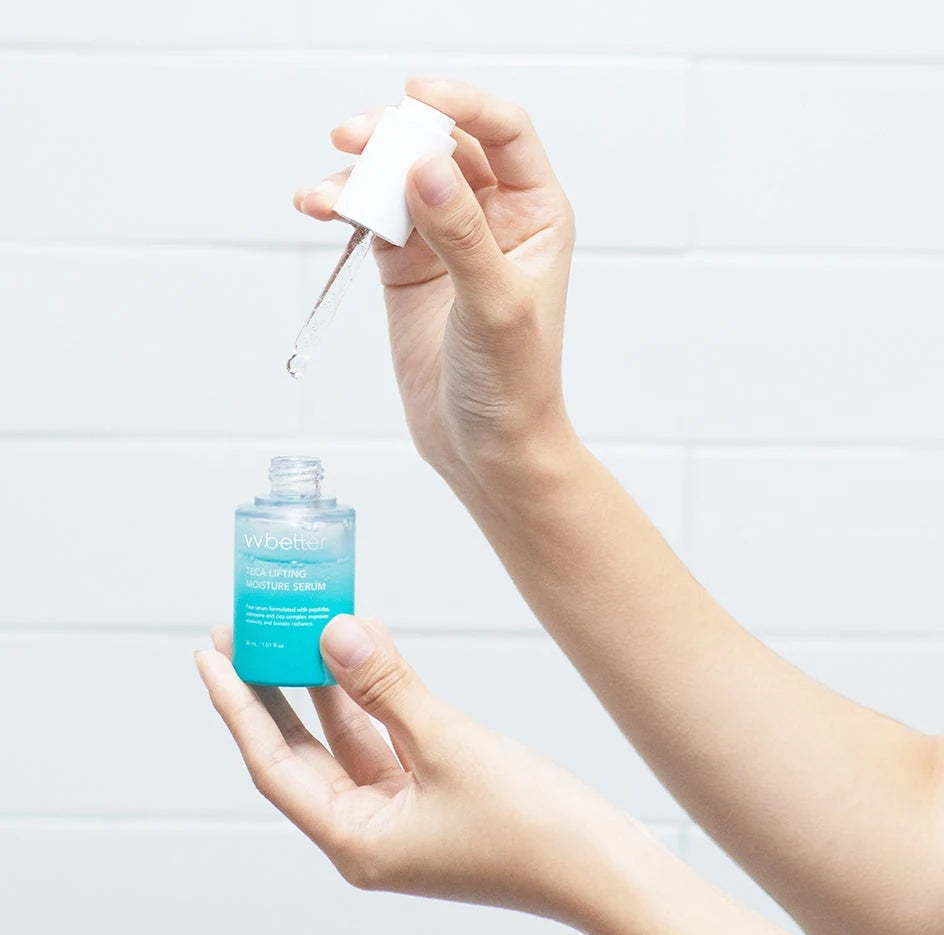 Hand lifting the glass dropper from an open VVBETTER TECA Lifting Moisture Serum bottle