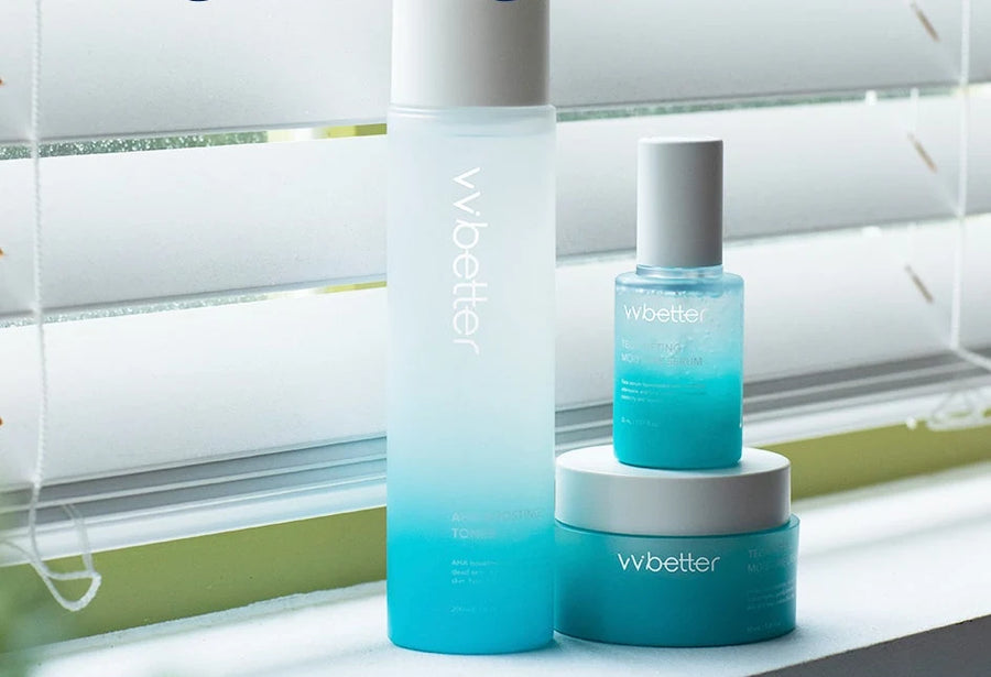 Toner, serum and cream on a window sill in front of white blinds