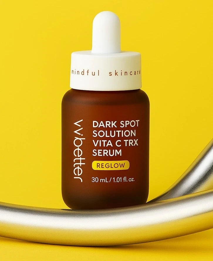 VVBETTER Dark Spot Solution Vita C TRX Serum, 30 mL bottle with its dropper, shown in full on a yellow background and a silver curve