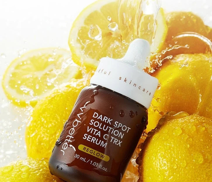VVBETTER Dark Spot Solution Vita C TRX Serum bottle among splashing lemons