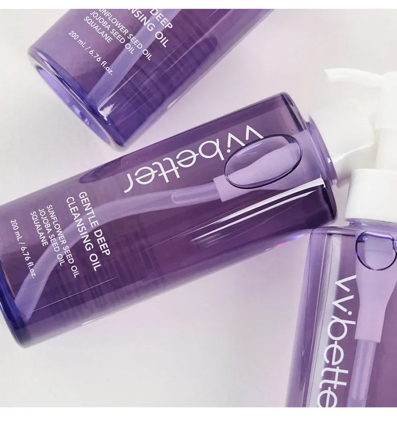 Gentle Deep Cleansing Oil purple pump bottles lying on a white surface, close-up