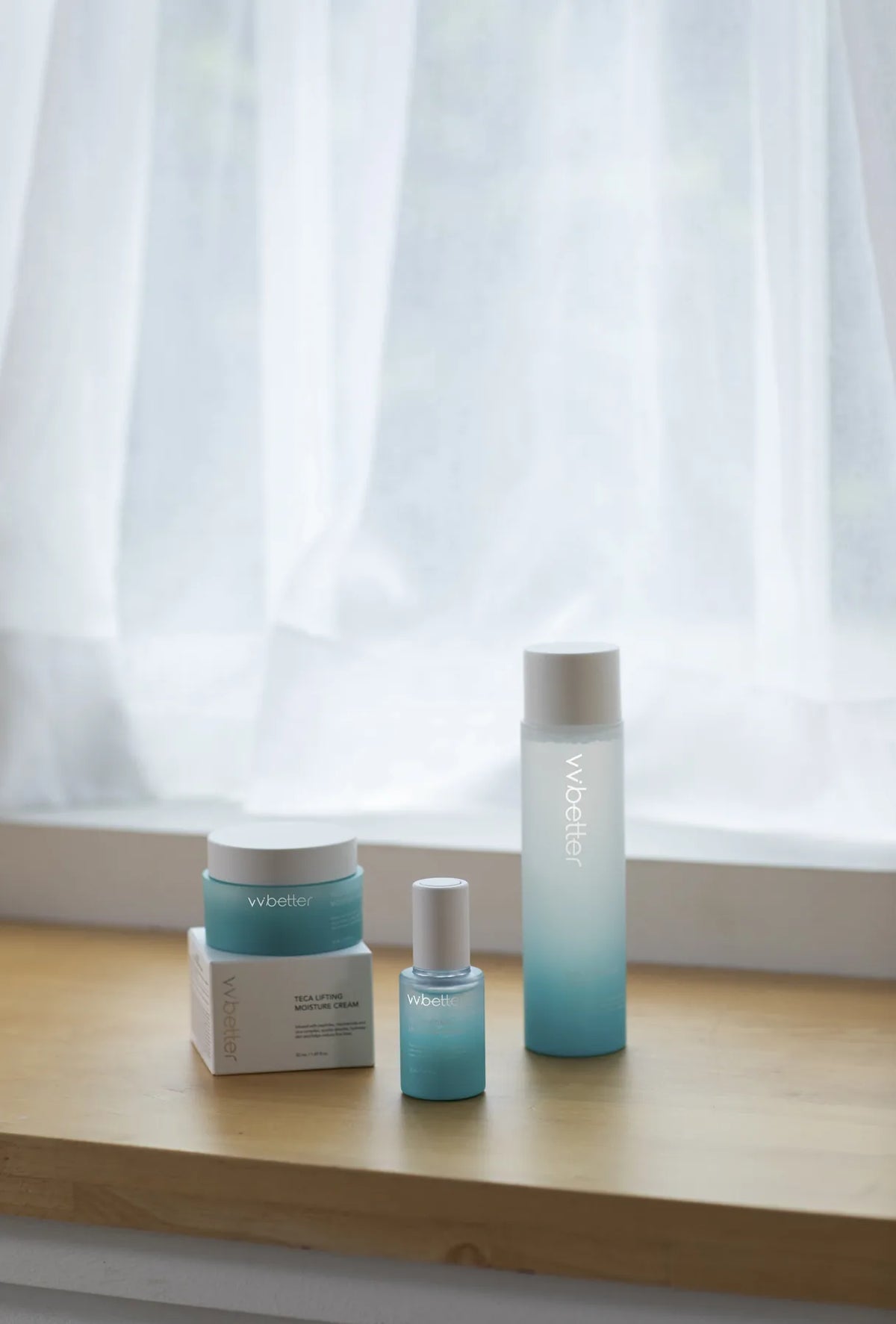 Blue Line cleansing, toner, serum and cream bottles on a wooden shelf in front of a sheer curtain