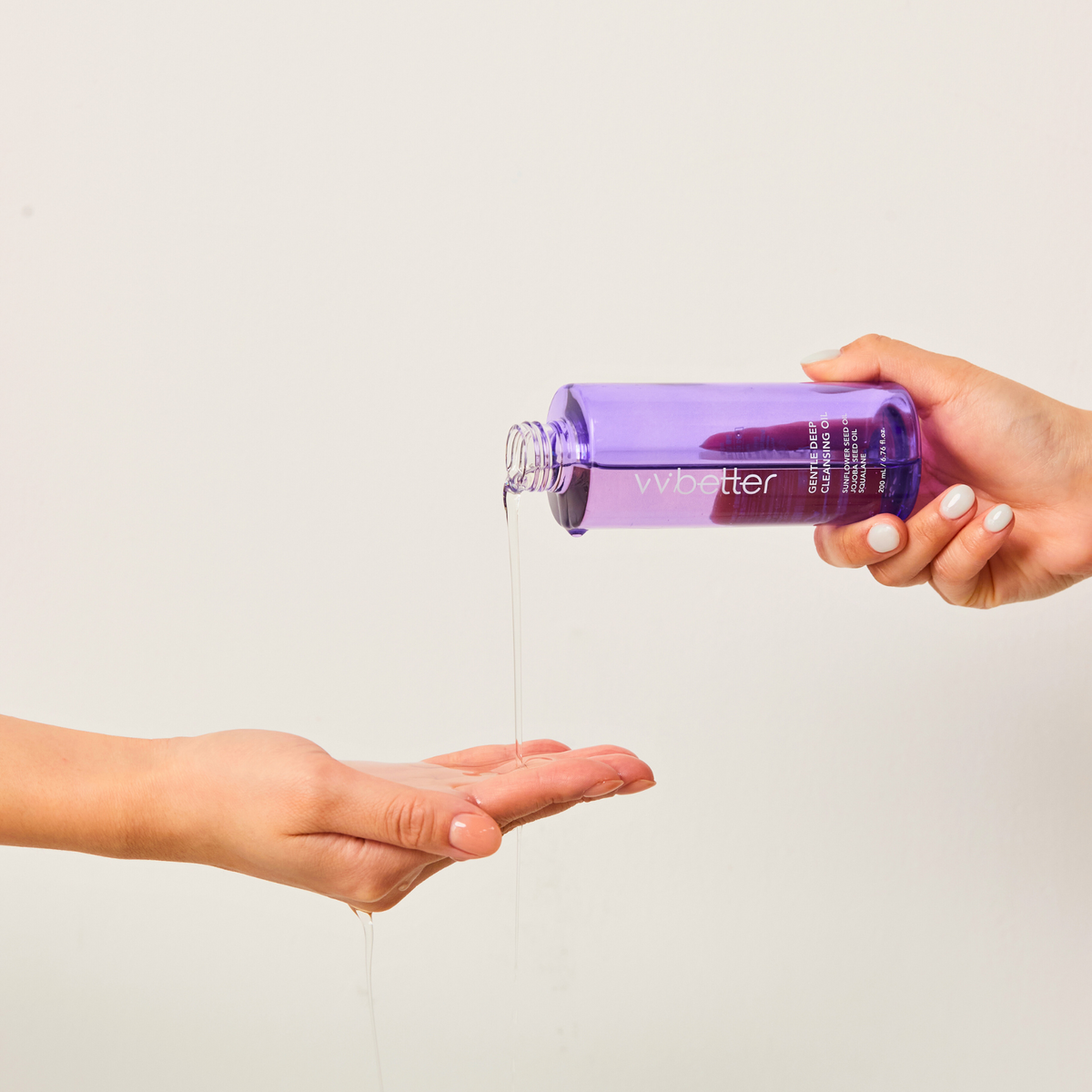 Gentle Deep Cleansing Oil — oil poured from the uncapped bottle into a palm, texture