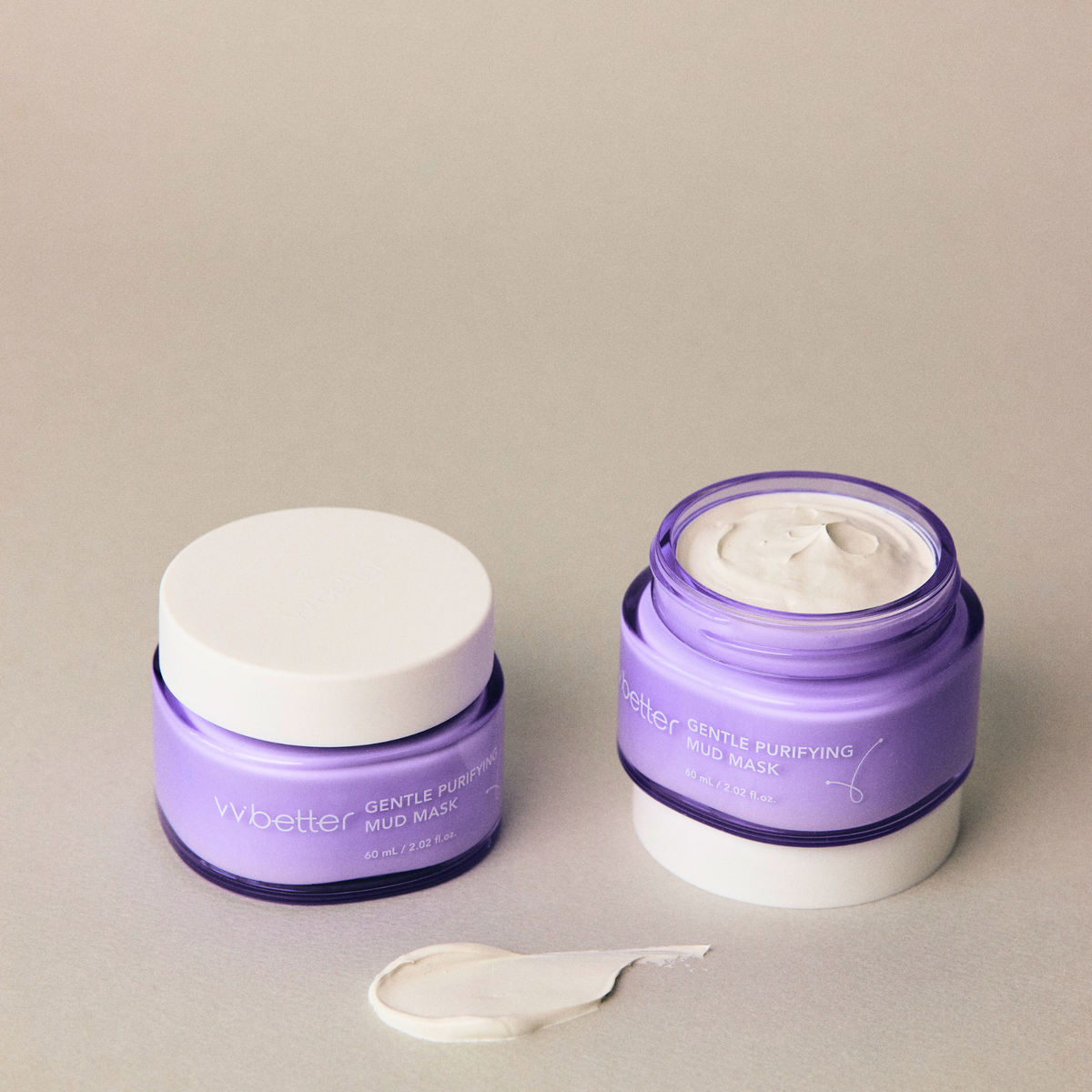 Gentle Purifying Mud Mask — two jars, one open showing the creamy clay, texture smear in front