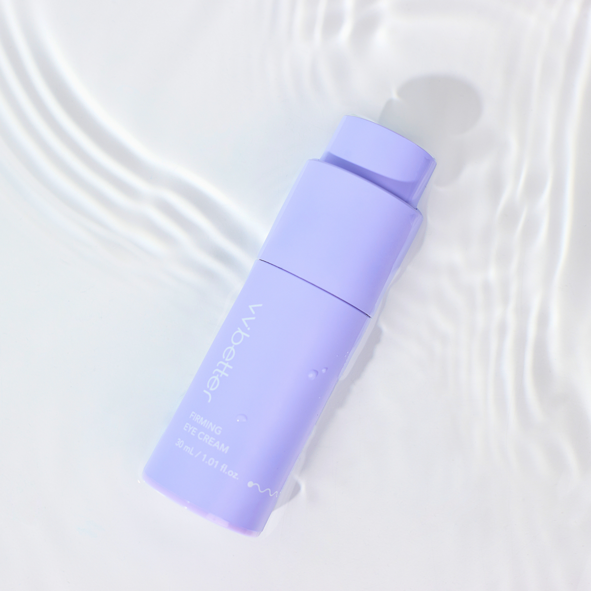 Firming Eye Cream — bottle lying in rippling water, overhead view