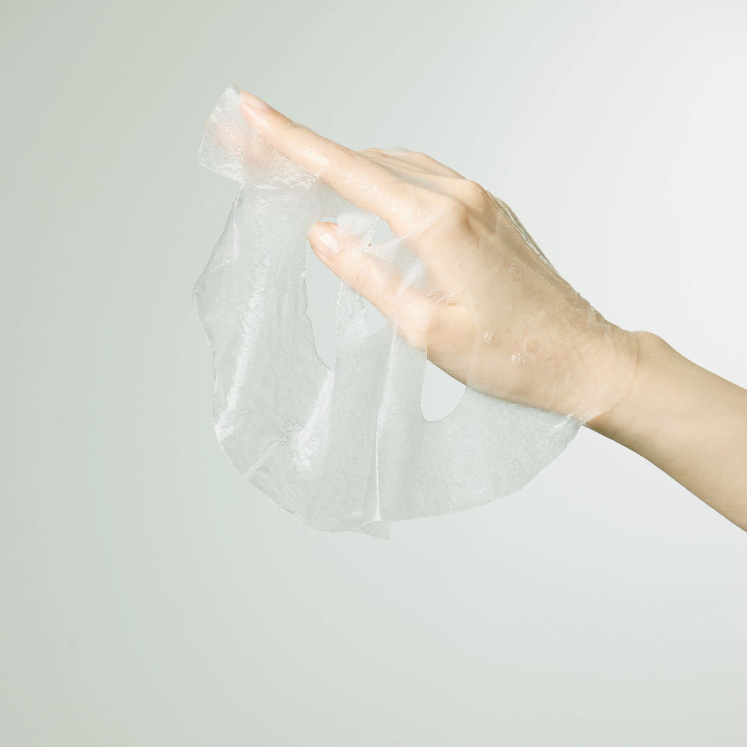 Rejuvenating Squalane Mask — translucent sheet mask draped over a hand, texture