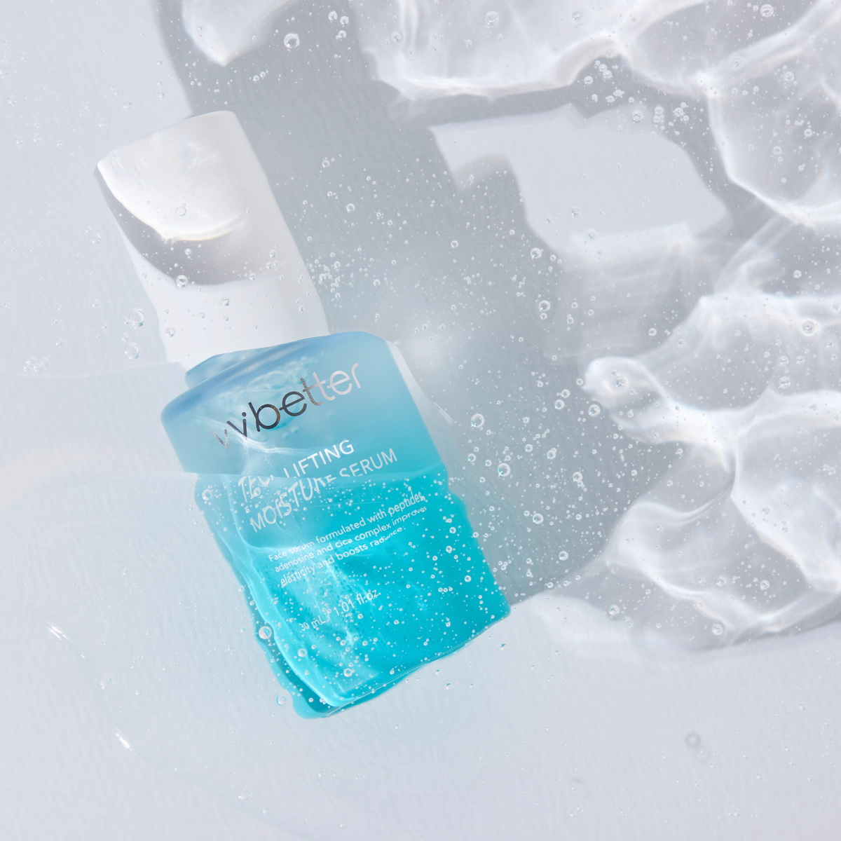 Teca Lifting Moisture Serum — bottle lying in rippling water, overhead view