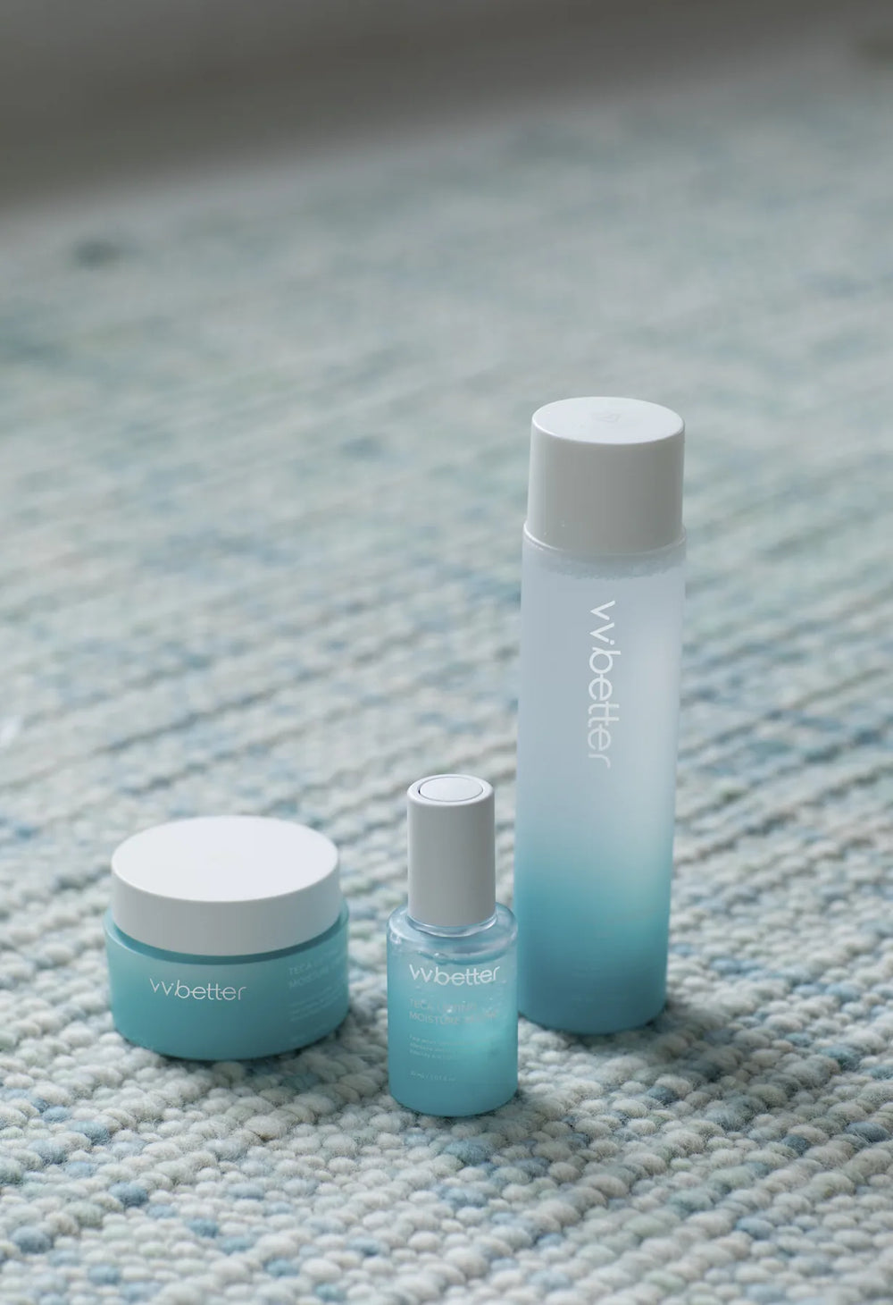Toner, serum and cream of the Blue Line standing on a woven blue rug