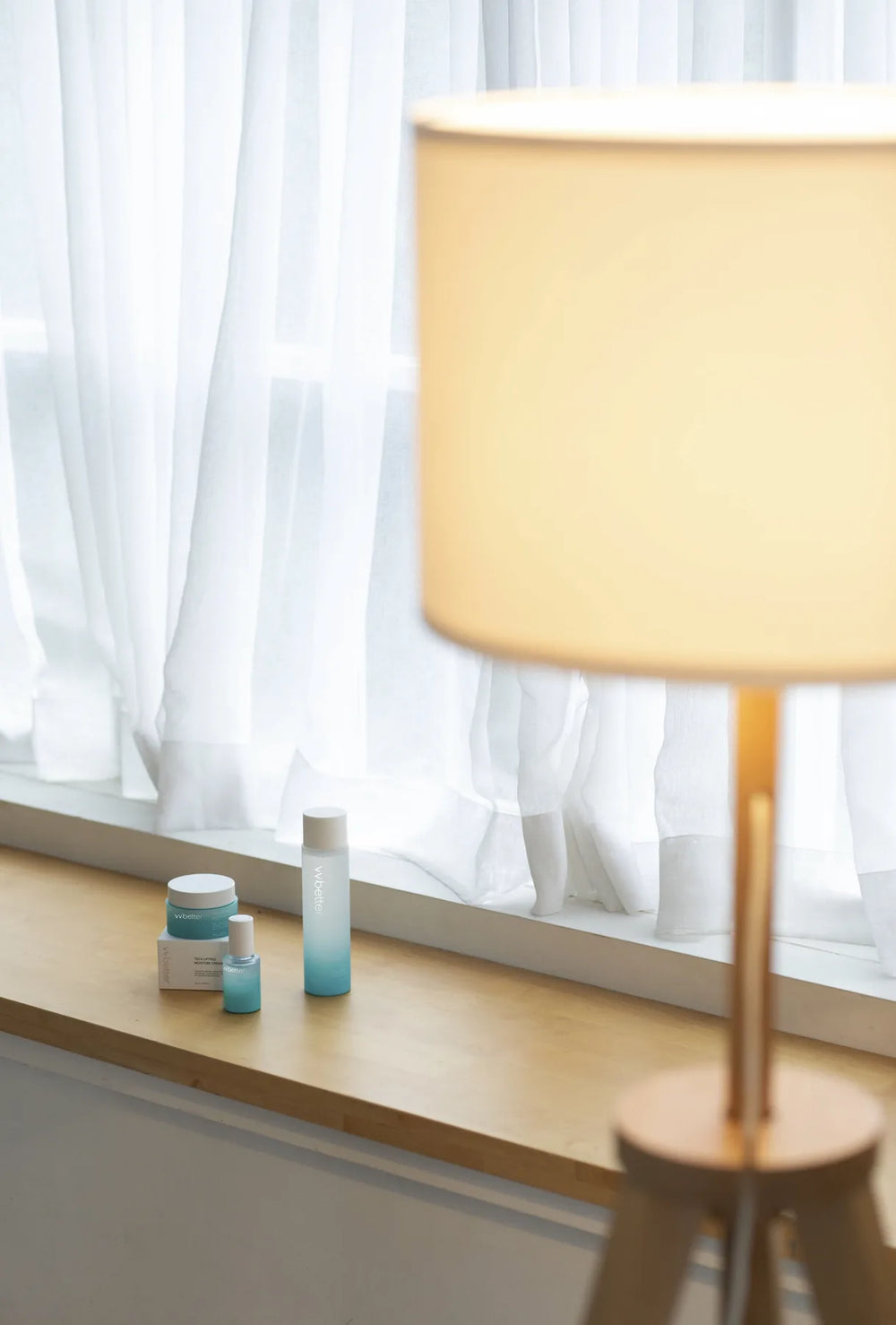 Blue Line products on a sunlit windowsill beside a warm lamp