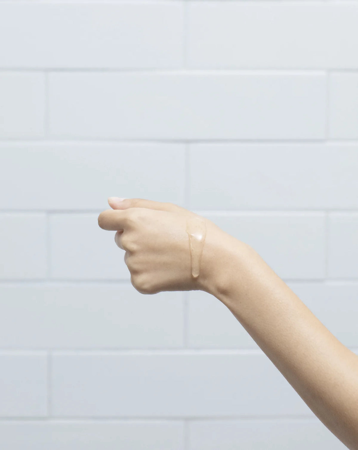 A thin clear swatch of product on the back of a wrist