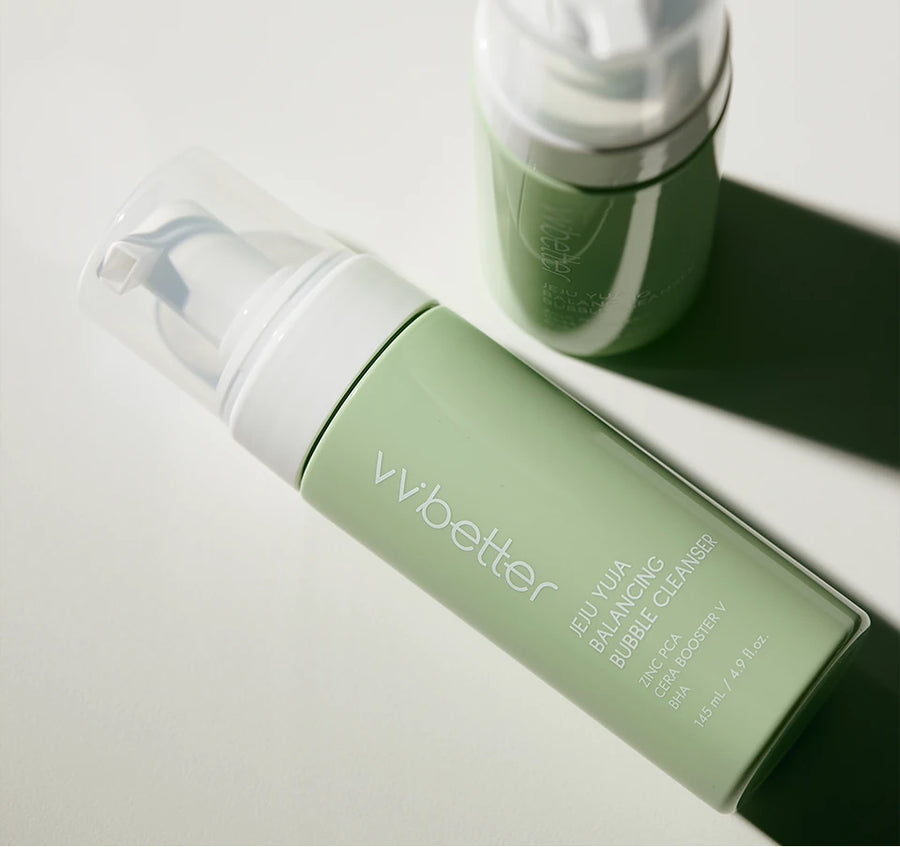 Two Bubble Cleanser bottles lying on white in bright sunlight