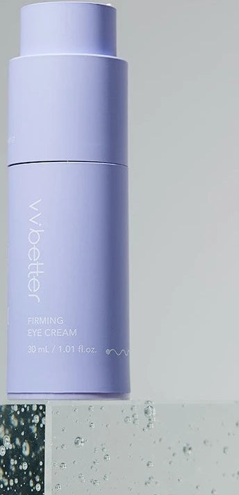 Firming Eye Cream bottle standing on a clear acrylic block