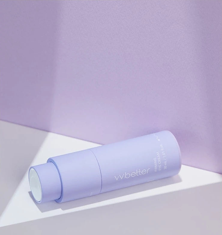 Firming Eye Cream bottle lying on a lilac and white set