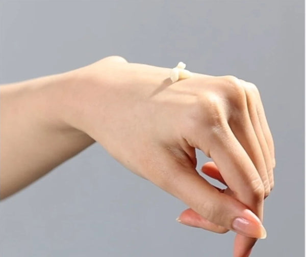 Dab of eye cream on the back of a hand
