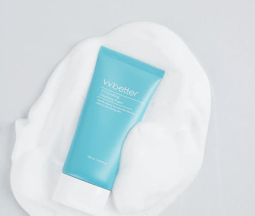 5.5 Soothing Cleansing Foam tube lying in a soft, creamy foam swatch