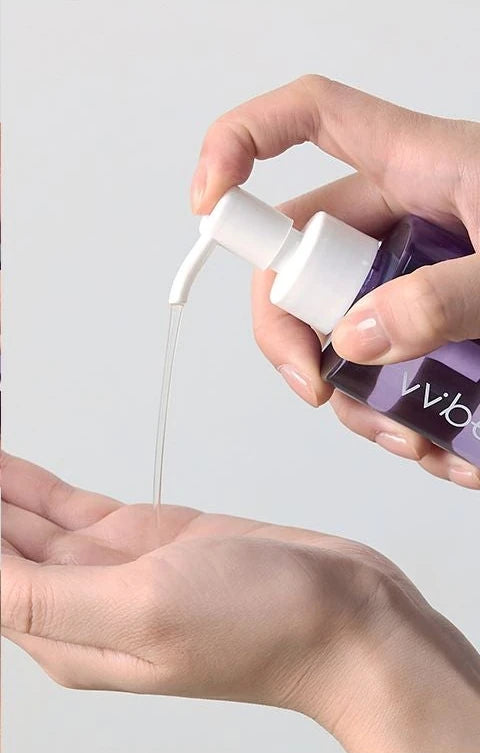 Cleansing oil dripping from the pump into a palm