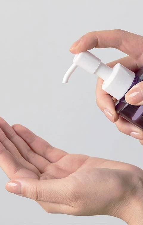 Hand pressing the pump over a palm