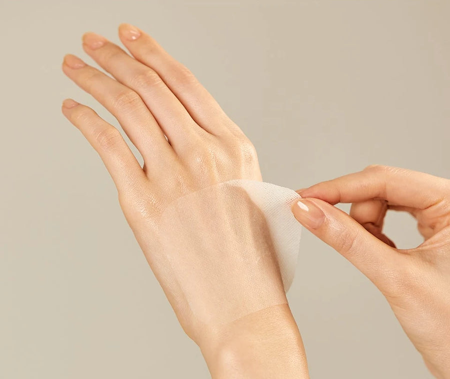 Hand smoothing a damp pad over the back of the other hand