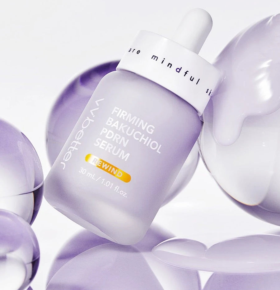 Firming Bakuchiol PDRN Serum bottle among lilac glass spheres