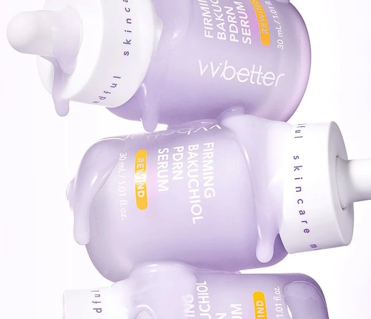 Firming Bakuchiol PDRN Serum bottles stacked sideways with lilac serum dripping over them