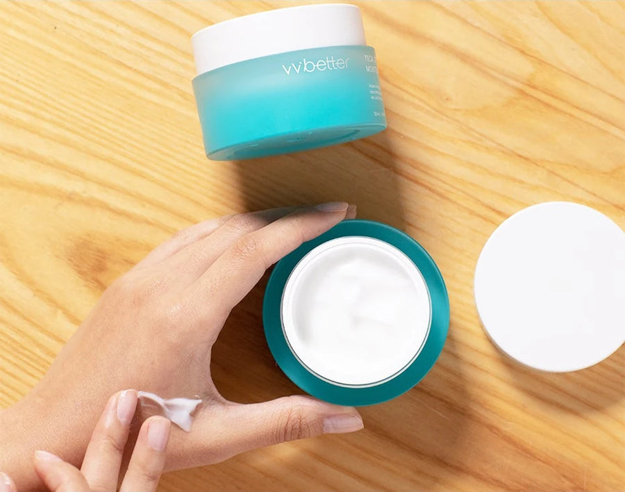 Hand taking cream from the open TECA Lifting Moisture Cream jar