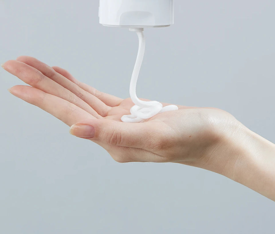 White formula squeezed from a tube into an open palm