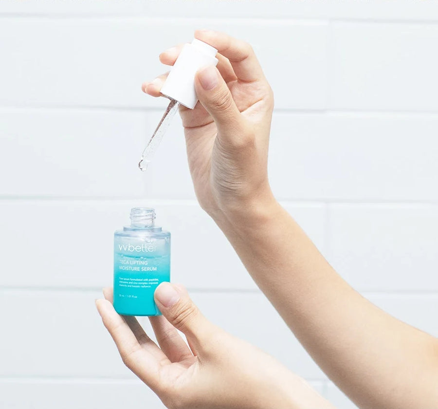 Hand lifting the dropper from the TECA Lifting Moisture Serum bottle