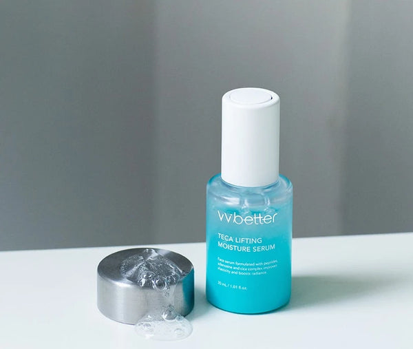 A drop of clear gel serum in a metal cap beside the bottle