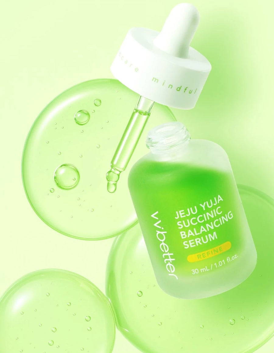 Open serum bottle with the dropper lifted, among clear green serum swatches
