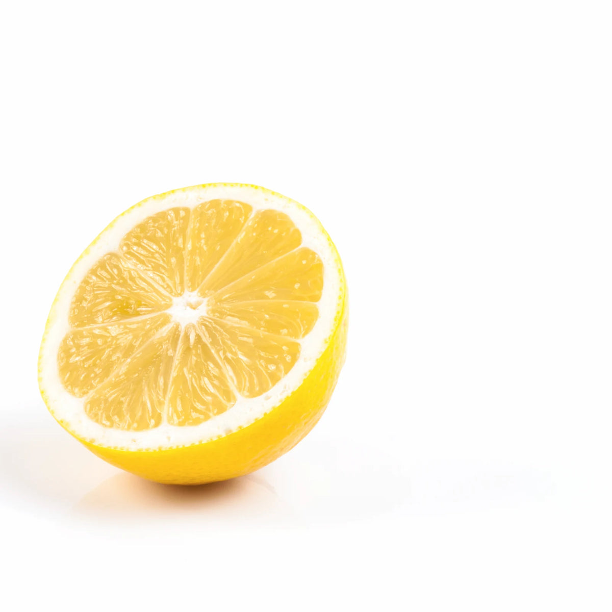 Half a fresh lemon, rich in citric acid, on a white background