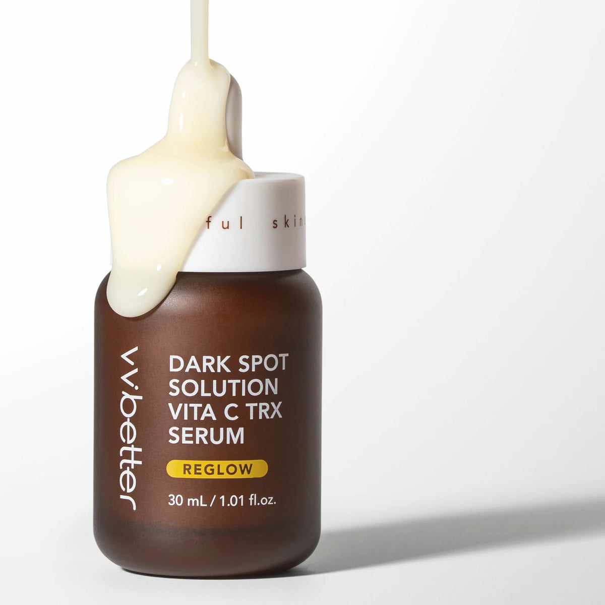 Rich serum spilling over the neck of the Dark Spot Solution Vita C TRX Serum bottle, which carries 3-O-ethyl ascorbic acid, on a white background