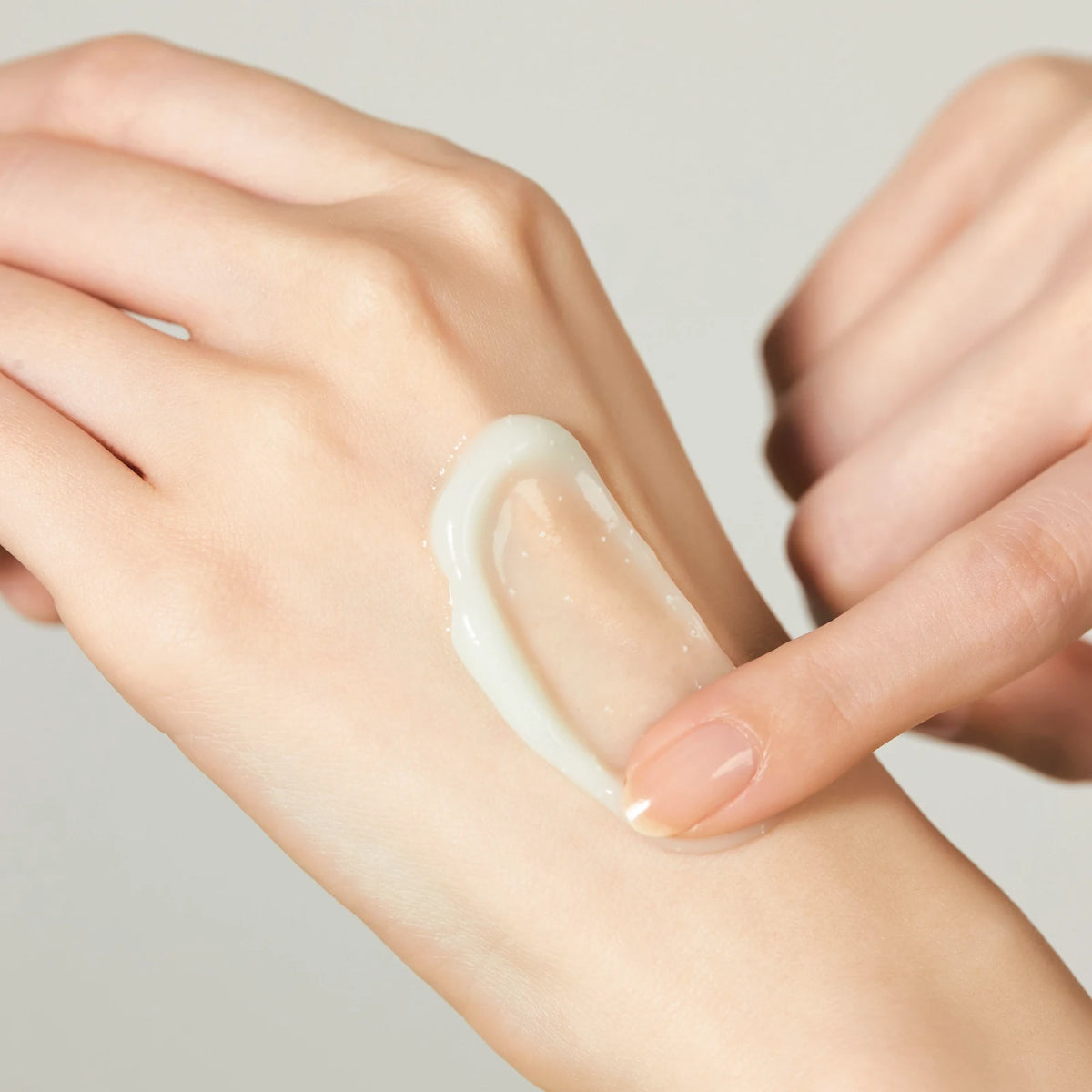 A swipe of Jeju Yuja Cera Balancing Cream, made with panthenol, being spread on the back of a hand