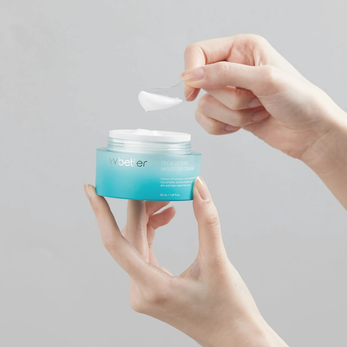 A scoop of white Teca Lifting Moisture Cream, made with nine peptides, lifted from the open turquoise jar