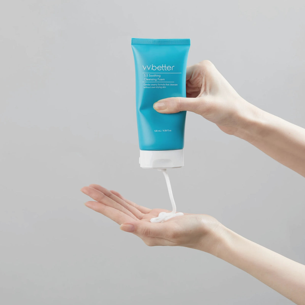 Creamy white 5.5 Soothing Cleansing Foam, made with sodium cocoyl isethionate, squeezed from the turquoise tube into an open palm